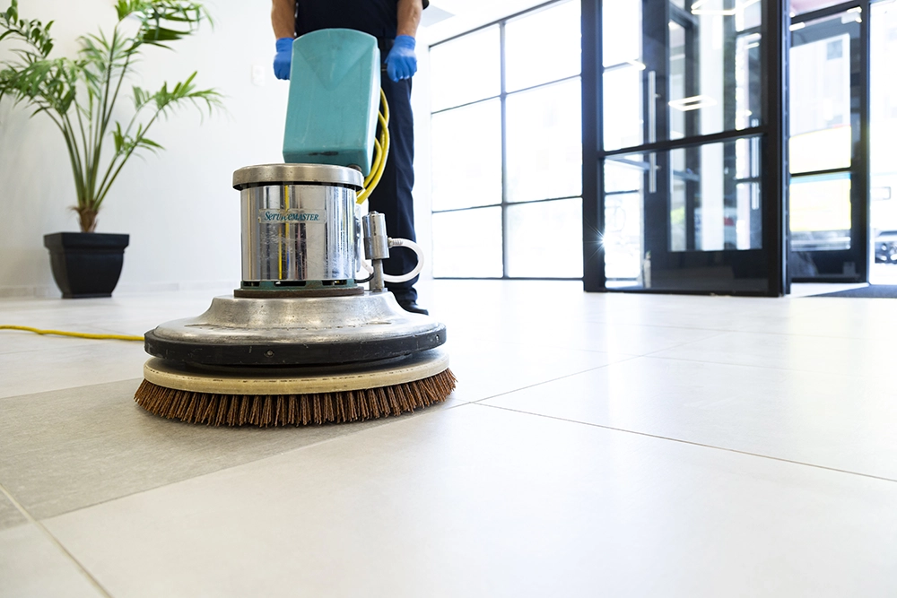 Male cleaning staff polishing lobby floor